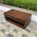 CoasterEveryday HP0426 Mango Coffee Table with wooden finish and modern design, shown from a front view in a living room setting.