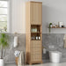 Giga tall bathroom linen cabinet with one door, three drawers, and open storage in wood finish.