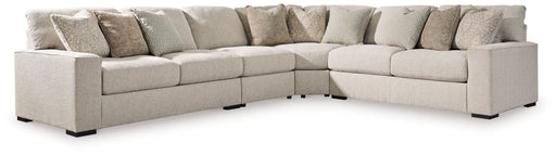 Benchcraft Ballyton 4-piece stationary sectional sofa in sand fabric, featuring plush cushions and modern design.