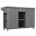 Giga outdoor kitchen island with stainless steel top, storage, towel and spice racks, and bottle opener in a backyard setting.