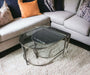 Pair of black marble top and glass nesting coffee tables by HomeRoots, showcasing sleek marble and transparent glass surfaces.