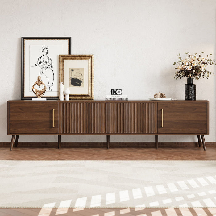 Giga walnut TV stand for up to 85-inch TVs with fluted door, cable management, and soft-closing hinges in a modern living room setting.