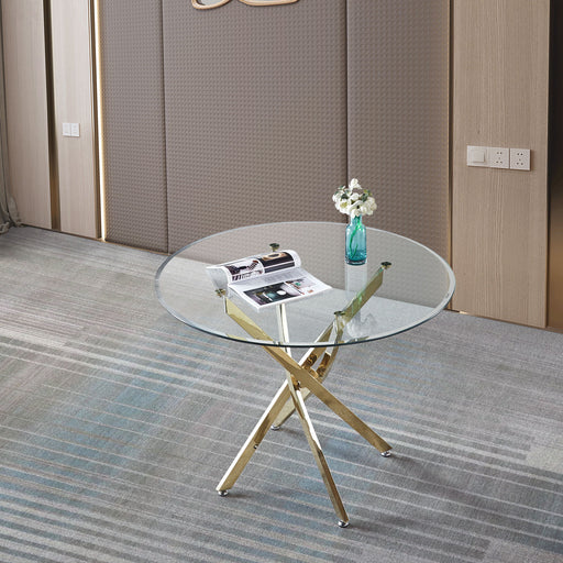 Contemporary round clear glass dining table with gold-finish stainless steel legs by Giga, perfect for modern dining spaces.