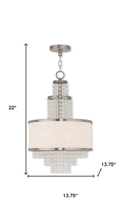HomeRoots 22-inch three-light metal chandelier with clear and off-white shades, dimmable with nickel finish and modern design.