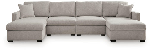 Benchcraft® ModMax Luxe 4-piece stationary sectional sofa with plush cushions and modern design, perfect for stylish living rooms.