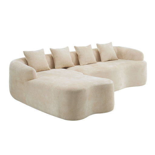 Giga modular L-shape sectional sofa with curved chaise, stationary design, tan fabric, and plush cushions in a modern living room setting.