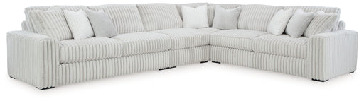 Signature Design by Ashley® Stupendous 4-piece stationary sectional sofa with plush cushions and modern design in a cozy living room setting.