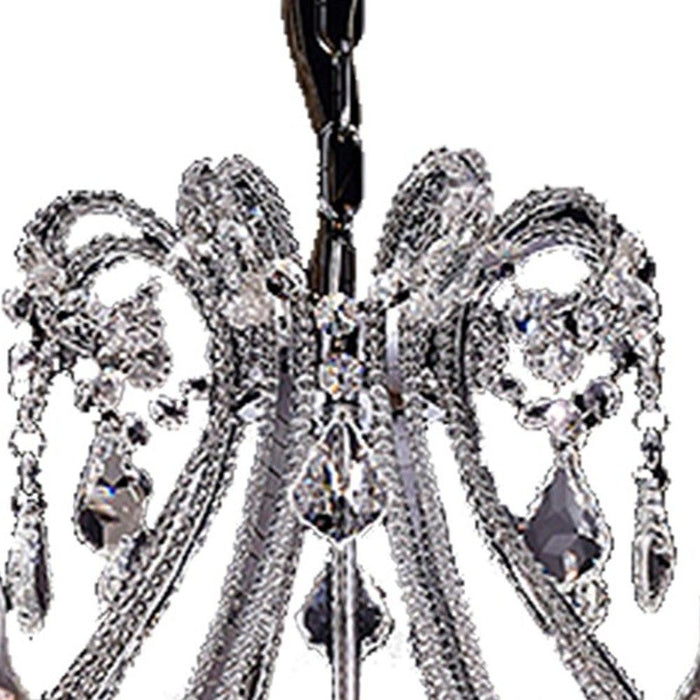 HomeRoots Empire Eight Light LED chandelier with transparent glass and nickel finish, featuring ivory candle-style lights and clear glass accents.