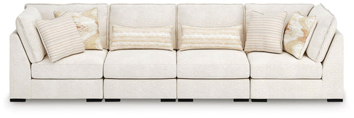 Benchcraft Donelson Creek 4-piece vanilla sectional sofa with plush cushions and modern design, shown in a stylish living room setting.