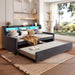 Dark gray Giga twin size storage daybed with trundle, LED light, and charging station, featuring a modern design and built-in storage drawers.