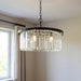HomeRoots black six-light metal crystal glass chandelier with shades, featuring an elegant, modern design and decorative lighting elements.