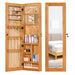 Giga jewelry armoire organizer with full-length mirror, wall-mounted lockable cabinet and LED lighting in a modern bedroom setting.