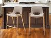 Set of 2 beige faux leather and steel low back counter height bar chairs with gold accents, designed for modern kitchen or bar areas.