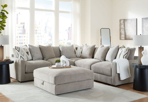 Benchcraft Aslan Court 6-piece sectional living room set with ottoman in pebble fabric, shown assembled in a modern living space.