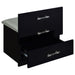 Black high gloss Danbury makeup vanity with three drawers and matching stool, featuring sleek modern furniture design.