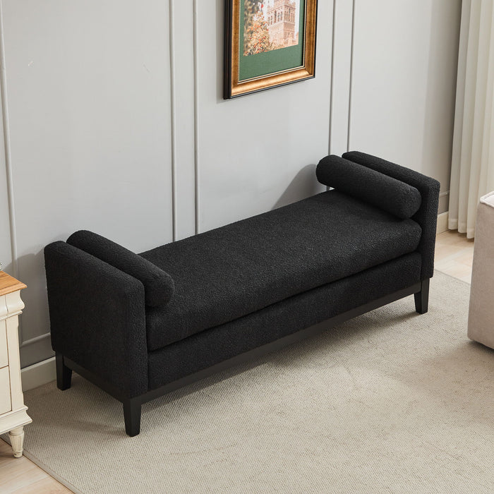 Black boucle upholstered bench with wood legs and two bolster pillows, designed as a versatile daybed or ottoman by Giga.