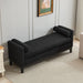 Black boucle upholstered bench with wood legs and two bolster pillows, designed as a versatile daybed or ottoman by Giga.