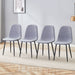 Set of four Giga luxury linen cotton dining chairs with black metal legs in light gray, featuring a simple, modern design.
