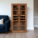 HomeRoots 42-inch brown solid wood and glass wine cabinet with four shelves, ideal for elegant storage and display.