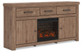 Signature Design by Ashley Garistyn TV stand with built-in fireplace option, featuring wood grain finish and multiple storage compartments.