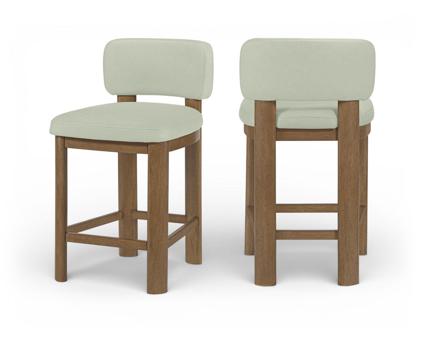Set of two Meridian Furniture Paloma faux leather counter stools with brown frames, featuring upholstered seats and modern design.