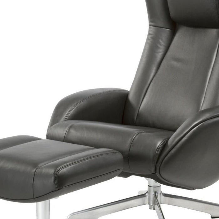 Black genuine leather tufted swivel recliner and matching ottoman by HomeRoots, featuring a plush, comfortable design.