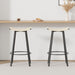 Set of two Giga backless counter height bar stools with handwoven cream-white seats and round footrests for kitchen or dining.