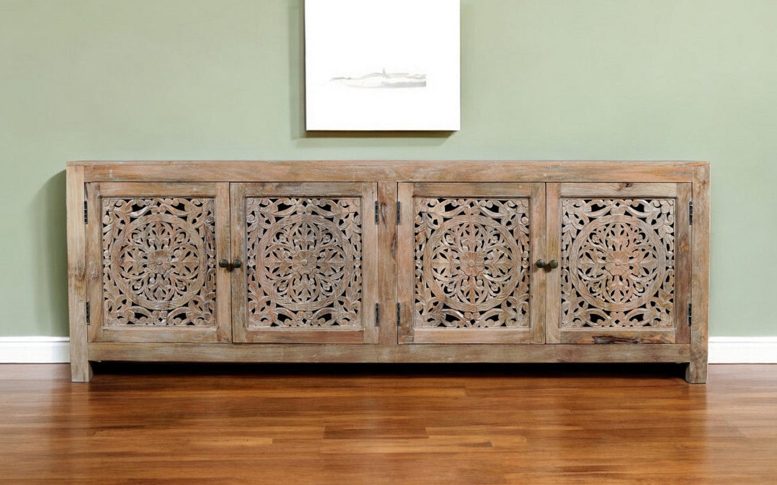 HomeRoots 86-inch carved floral distressed solid wood TV stand with enclosed storage and natural finish, featuring ornate carved details.