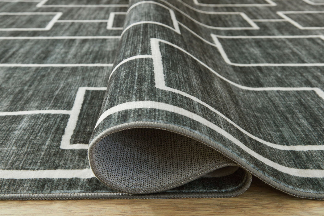 Elderland washable rug by Signature Design by Ashley® featuring a modern geometric pattern in neutral tones.