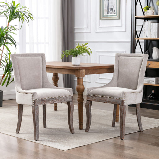 Set of two Giga Ultra Side Dining Chairs with nail head accents, modern design and upholstered seats for stylish dining spaces.