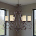 HomeRoots 27-inch bronze metal chandelier with six shades, dimmable lighting and elegant cream shades for stylish interior decor.