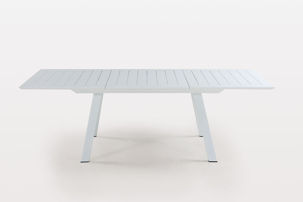 Contemporary Malibu outdoor extendable dining table by Chintaly in matte white aluminum with butterfly leaf for outdoor dining.
