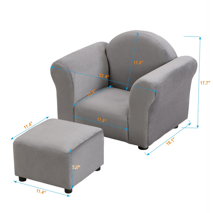 Gray kids velvet upholstered stationary chair with matching ottoman, featuring a plush seat and sturdy wooden legs.