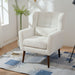Giga modern upholstered accent armchair with soft padding, wooden legs, and pillow, perfect for living rooms or bedrooms.