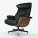 Black tufted genuine leather lounge chair and ottoman with walnut accents, stainless steel frame, and modern stationary design.