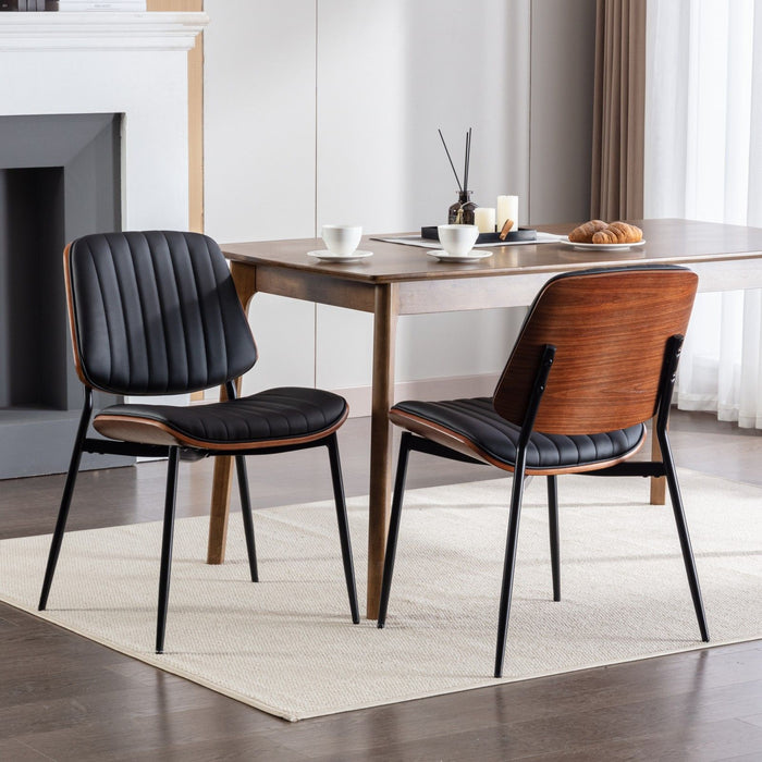 Set of 2 Giga mid-century modern dining chairs with walnut bentwood back and upholstered seat, metal legs with adjustable feet.