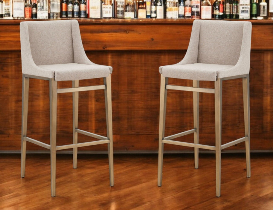 Set of two beige and gold stainless steel bar height chairs by HomeRoots, featuring modern design and comfortable seating.
