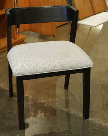 Set of two black upholstered dining side chairs from Signature Design by Ashley®, featuring plush cushioning and wooden legs.