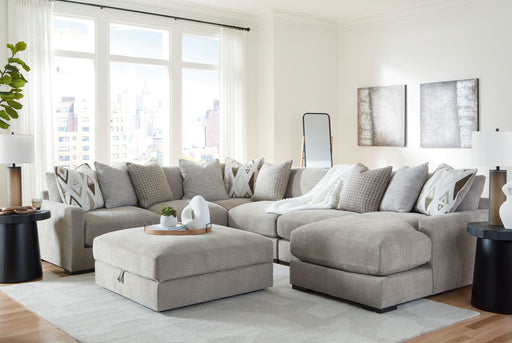 Benchcraft Aslan Court 7-piece sectional with raf corner chaise and ottoman in pebble fabric, showing plush cushions and modern design.