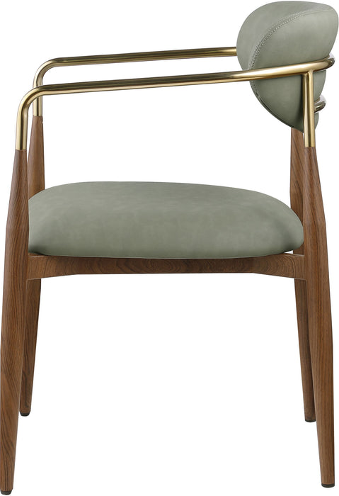 Vegan leather upholstered Meridian Furniture Ronda dining arm chair with walnut wood legs, showcasing a modern, plush design.