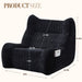 Giga oversized black bean bag chair with armrests, plush lounge sofa for living room relaxation and casual seating.