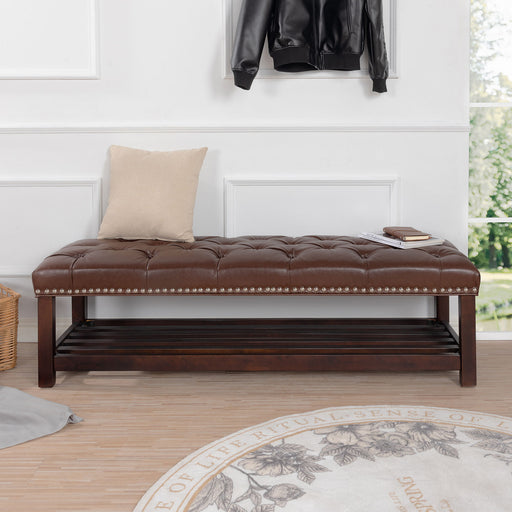 Giga upholstered end of bed bench with tufted design, nailhead trim, wooden shelf, and padded footstool for bedroom or living room.