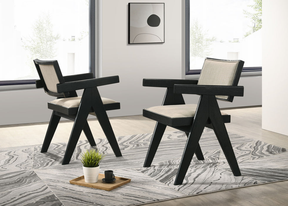 Set of two Giga Jasper dining arm chairs with upholstered beige seats and ebony black frames, ideal for modern dining rooms.