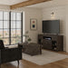 Giga Farmington TV stand in oak finish holding a 60-inch TV with open shelves and storage compartments.