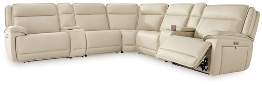 Signature Design by Ashley® 7-piece power reclining sectional in almond with two consoles, showcasing plush cushions and reclining features.