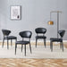 Set of four Giga minimalist ergonomic dining chairs with curved backrests, modern design, and comfortable seating.