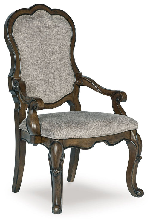 Set of two dark brown upholstered dining arm chairs from Signature Design by Ashley® with plush seats and curved armrests.