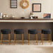 Set of 2 Giga contemporary round upholstered bar stools with wooden legs, ideal for kitchens, coffee shops, and bar areas.