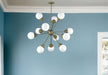 HomeRoots Sputnik twelve-light chandelier with frosted metal and off-white shades, bronze finish, dimmable design.