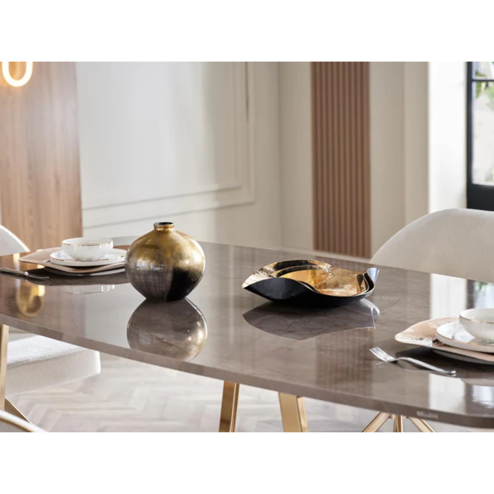 Bellona Veronica dining table with sleek wooden surface and modern design, shown in a well-lit dining room setting.